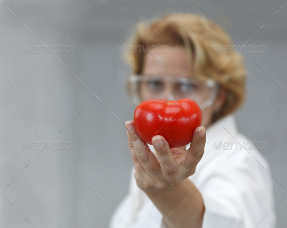 Researcher Giving a Tomatoe - Stock Photo - Images