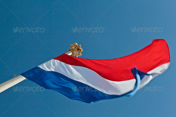 Dutch flag with a crown on top of the flagpole - Stock Photo - Images