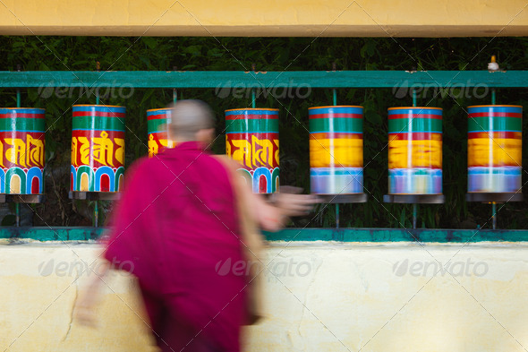 Buddhist monk rotating prayer wheels in McLeod Ganj - Stock Photo - Images