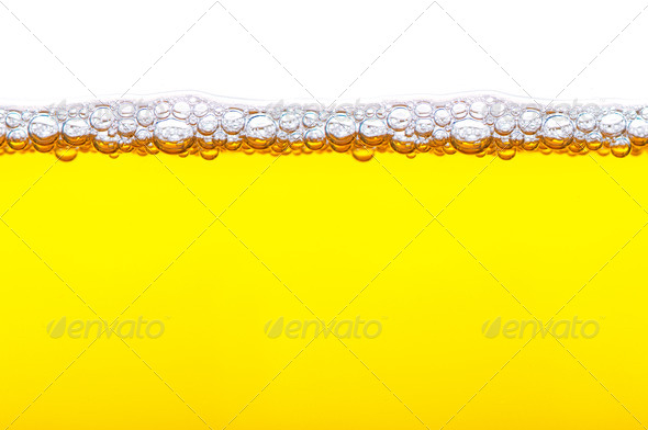 close up shot of yellow beer with foam and bubbles on white back - Stock Photo - Images