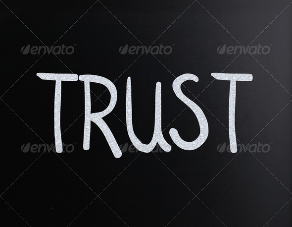 The word "Trust" handwritten with white chalk on a blackboard - Stock Photo - Images