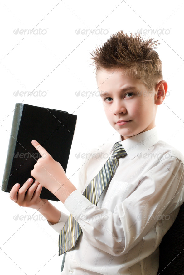 serious boy points his finger at the book - Stock Photo - Images