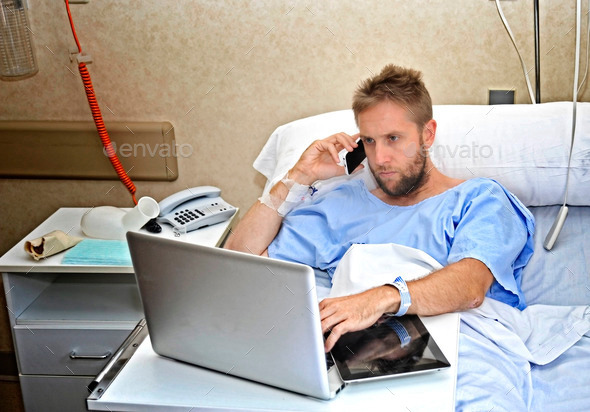 business%20man%20in%20hospital%20room%20lying%20in%20bed%20sick%20working%20with%20mobile%20phone%20computer%20laptop%2005.JPG