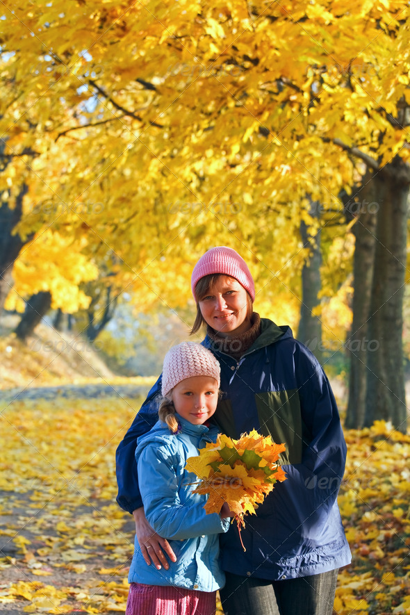 Family in autumn maple park - Stock Photo - Images