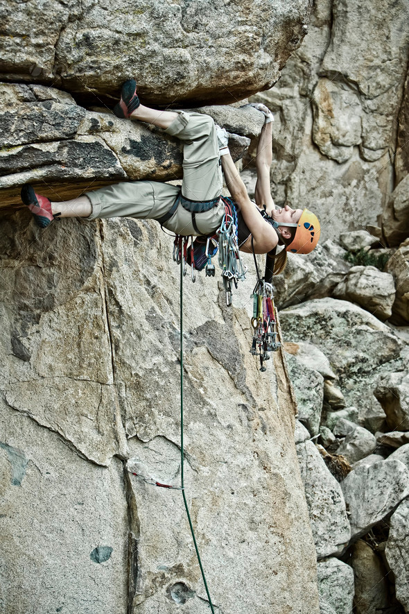 Rock climber clinging to a steep cliff. - Stock Photo - Images
