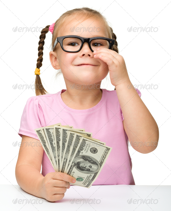 Cute little girl with paper money - dollars - Stock Photo - Images