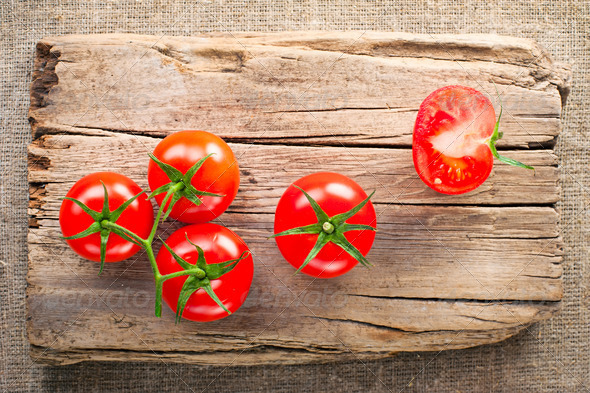 Fresh tomatoes on vintage wooden cutting board - Stock Photo - Images