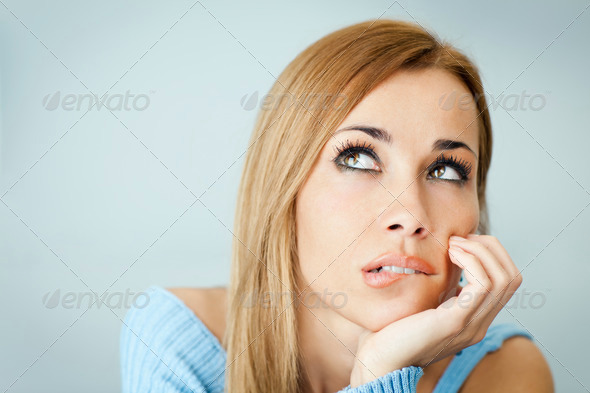 pensive woman biting lips - Stock Photo - Images