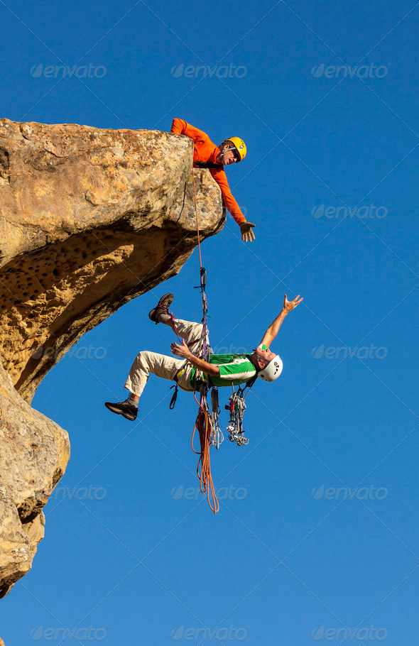 Climbing team struggles to the summit. - Stock Photo - Images