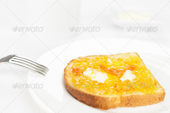 Breakfast. French toast, orange marmalade, butter, fork and white cup - Stock Photo - Images