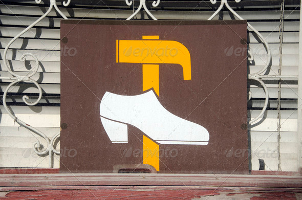 Shoe repair shop sign on window. hammer and shoe - Stock Photo - Images