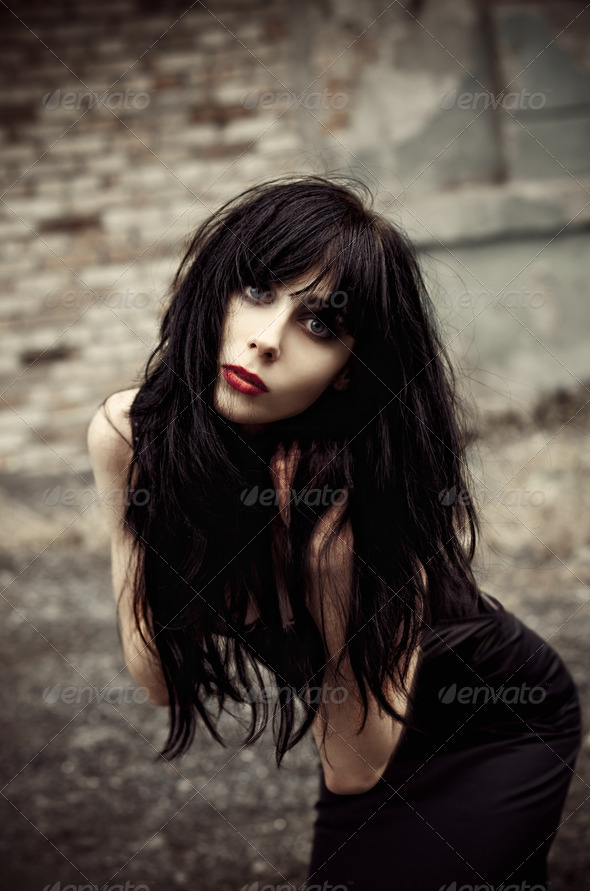 Beautiful goth girl among the ruins