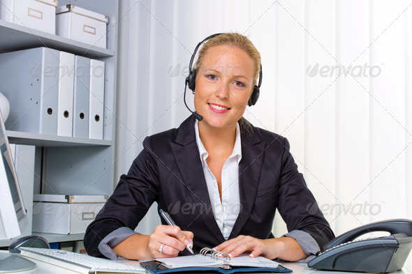 friendly woman with a headset in customer service - Stock Photo - Images