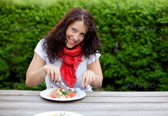 Beautiful Brunette Woman Eating a Salad - Stock Photo - Images