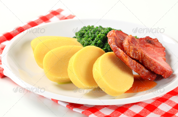 Smoked pork neck with potato dumplings and spinach - Stock Photo - Images