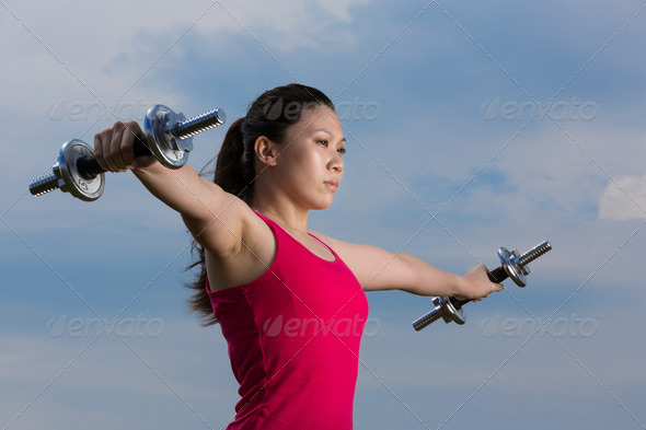 Chinese woman exercising with dumbbells - Stock Photo - Images