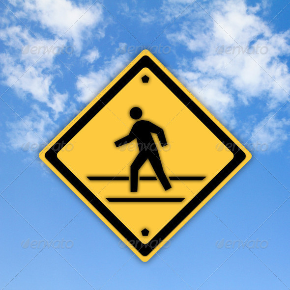 Crosswalk sign with a man walking on yellow with a blue sky back - Stock Photo - Images