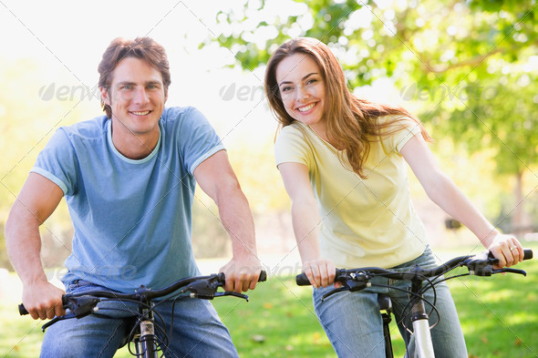 Stock Photo - PhotoDune Couple on bikes outdoors smiling 337635 Stock Photo - PhotoDune Couple on bikes outdoors smiling 337635