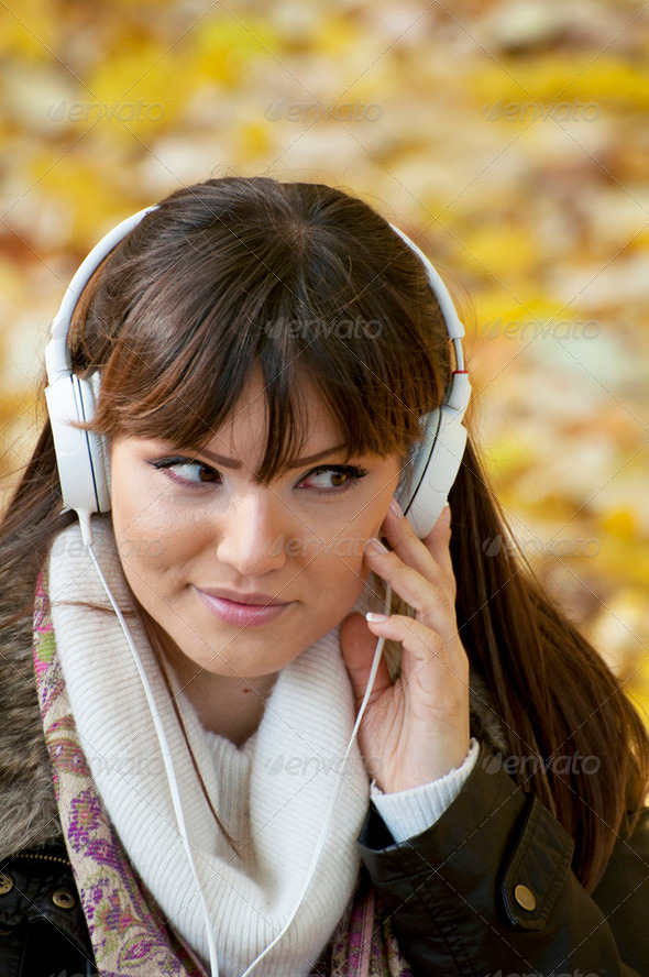 Closeup portrait of a beautiful happy woman listening to music - Stock Photo - Images