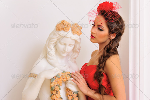 beautiful woman in red with antique statue. - Stock Photo - Images