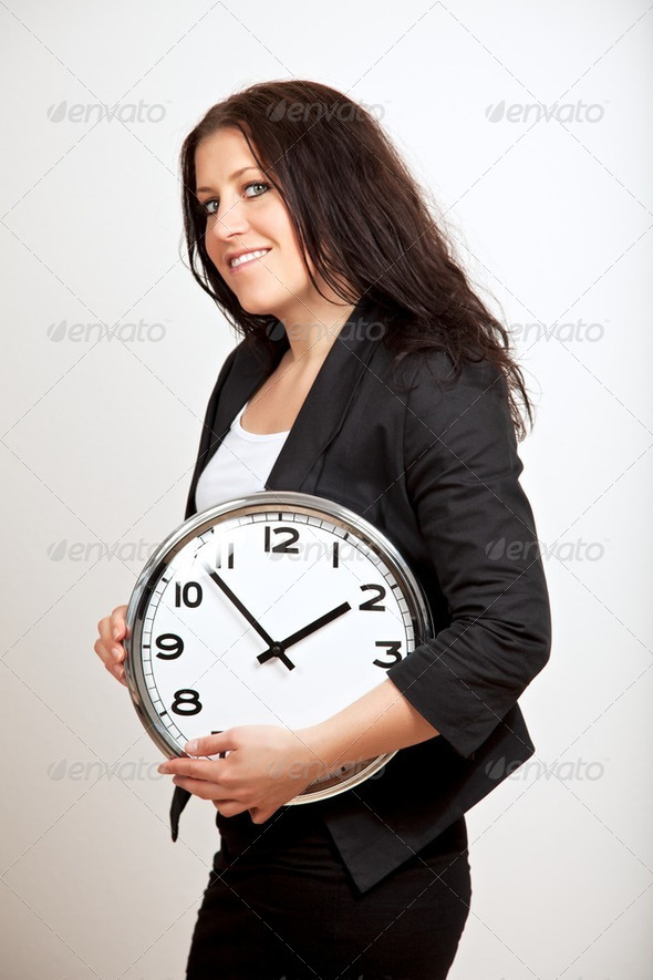 A Confident Woman Holding a Clock - Stock Photo - Images