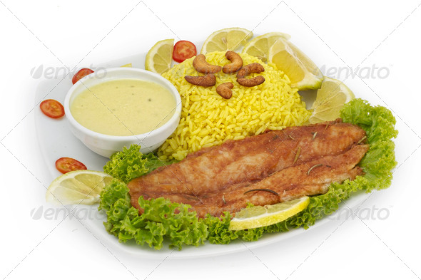 Plate with roasted fish, wild rice and vegetable garnish. - Stock Photo - Images