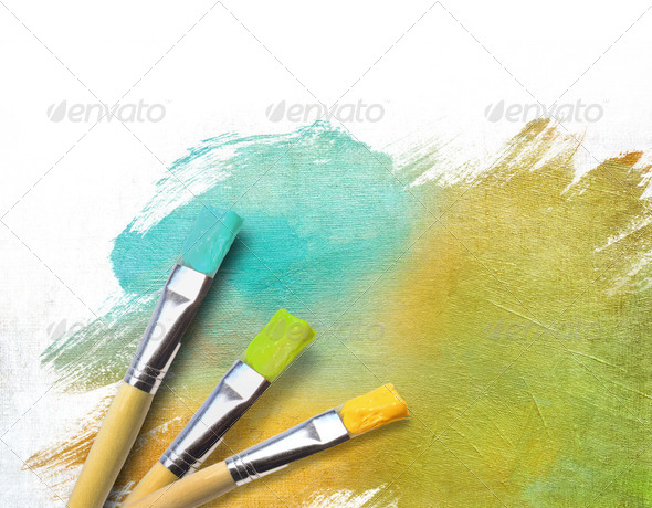 Artist brushes with a half finished painted canvas - Stock Photo - Images