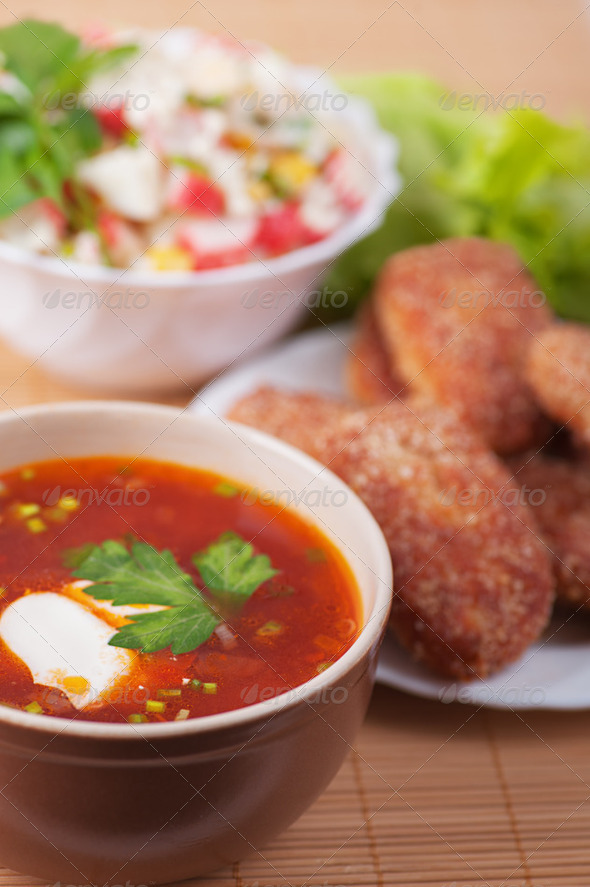 Burgers, crab salad and Russian borscht - Stock Photo - Images