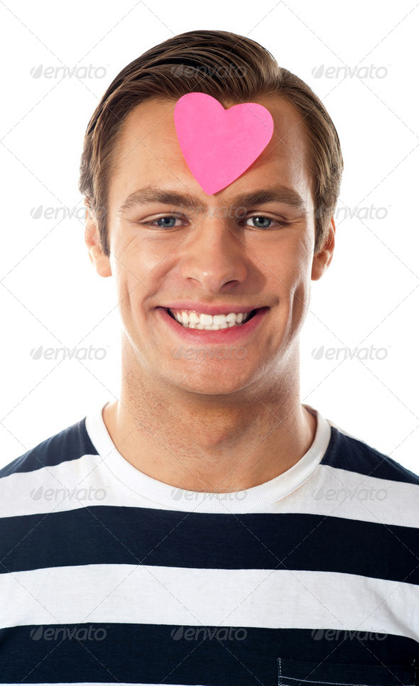 Closeup of an attractive man with paper heart - Stock Photo - Images
