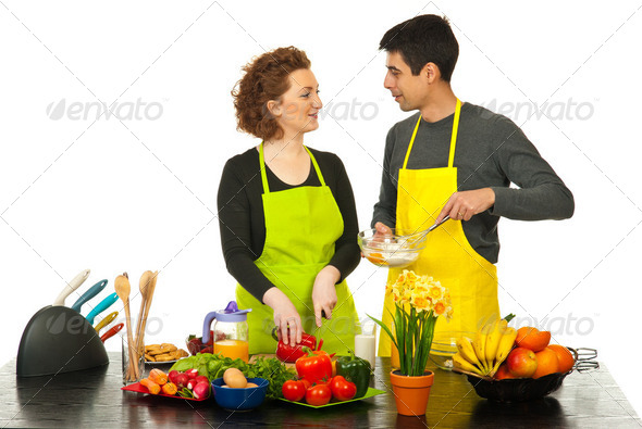 Happy couple cooking together - Stock Photo - Images