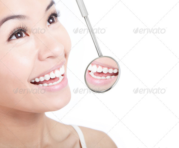 Healthy woman teeth and a dentist mouth mirror - Stock Photo - Images