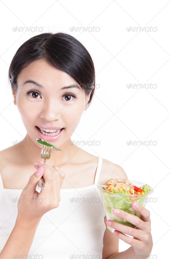 Young Girl Smile eating salad - Stock Photo - Images