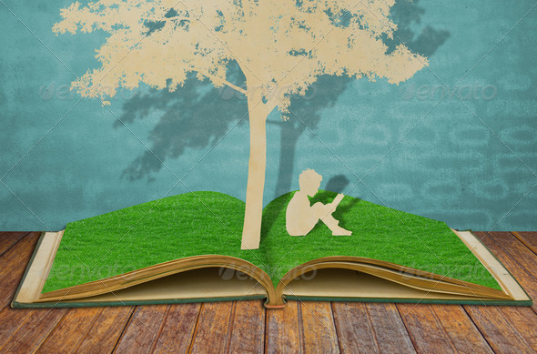 Paper cut of children read a book under tree on old book - Stock Photo - Images