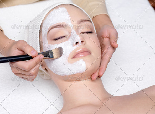 Woman having a facial cosmetic mask - Stock Photo - Images