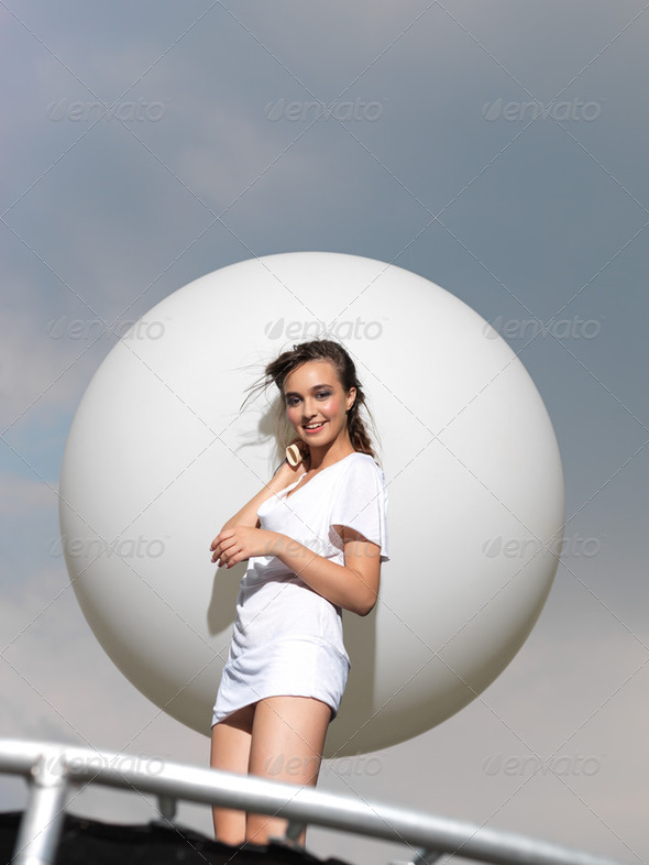 young woman on trampoline with white balloon - Stock Photo - Images