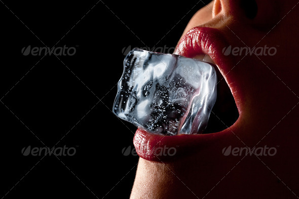 Ice cube in woman's mouth. - Stock Photo - Images