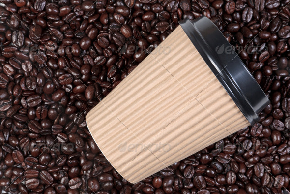 Takeaway coffee cup on arabica beans - Stock Photo - Images