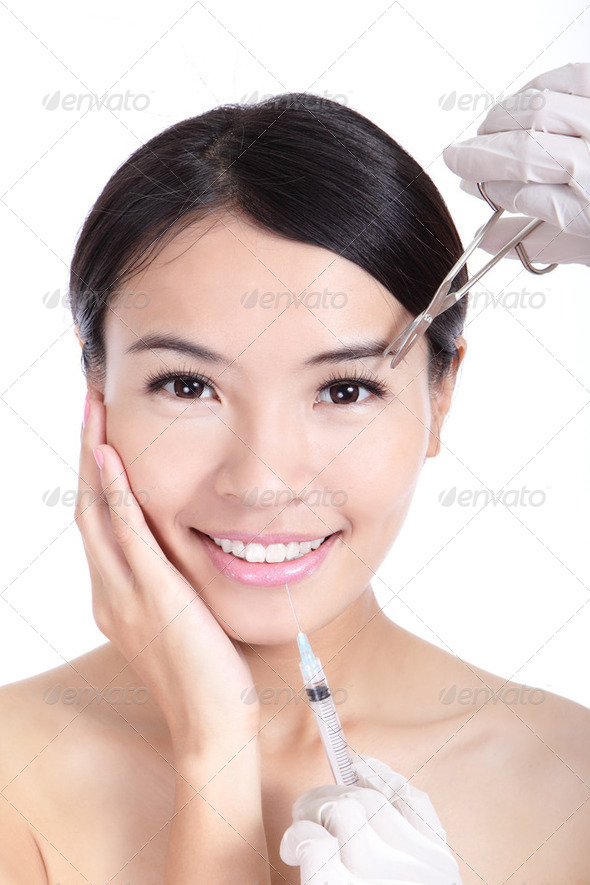 woman smile receiving a injection in her lip - Stock Photo - Images