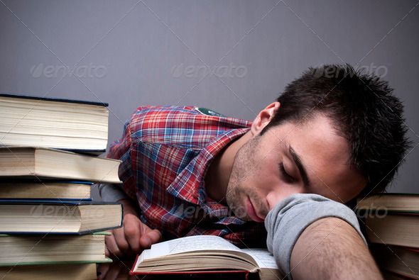 Young man sleeping on books - Stock Photo - Images