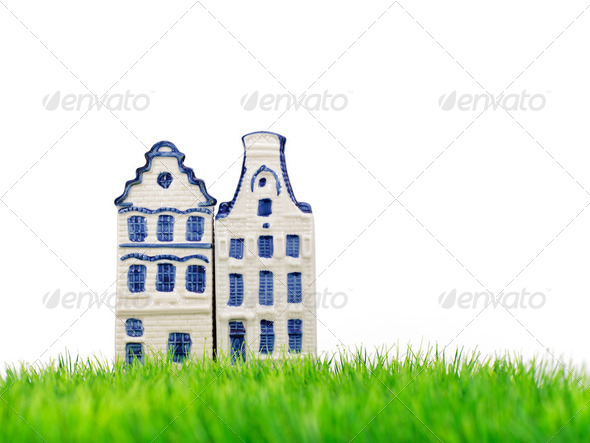 Two miniature Amsterdam canal houses on grass - Stock Photo - Images