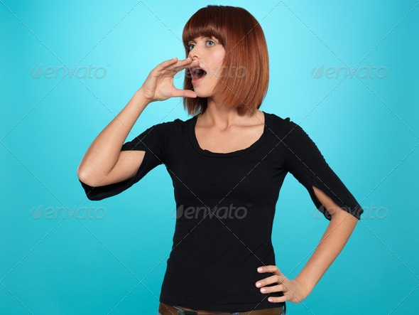 pretty woman shouting with hand at mouth - Stock Photo - Images