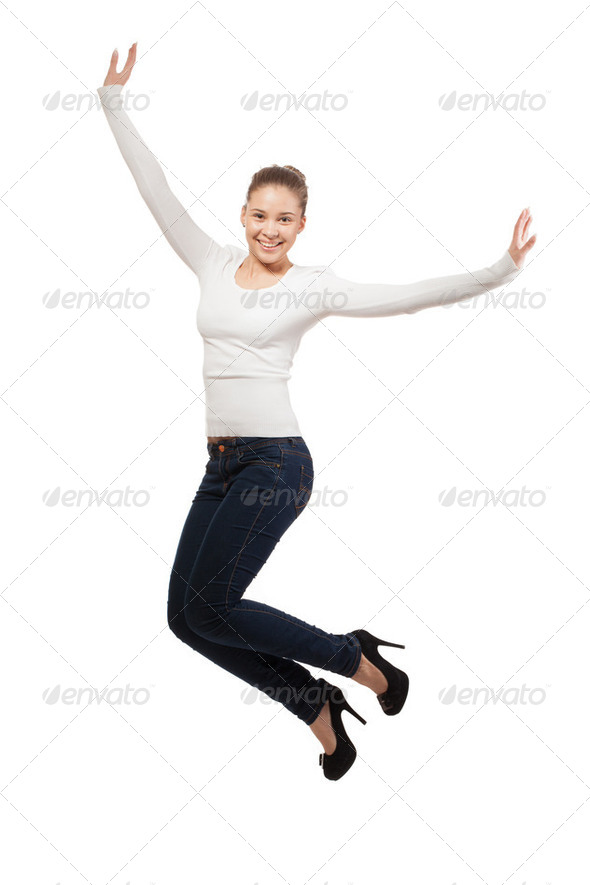 Casual woman jumping in joy. isolated over a white background - Stock Photo - Images
