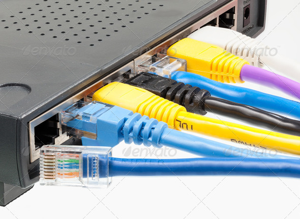 Cat 5 cables in multiple colors in router - Stock Photo - Images