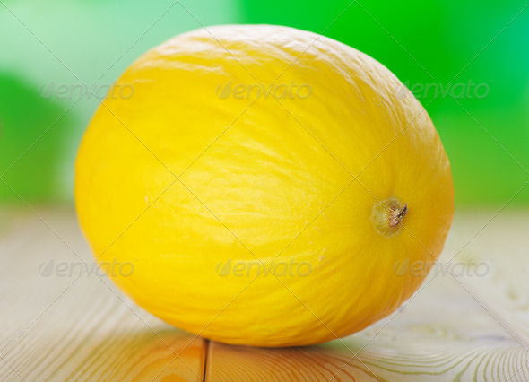 Yellow melons on wooden table - Stock Photo - Images