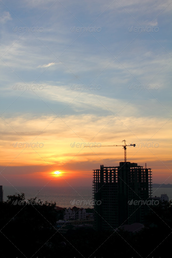 buildings under construction with cranes in nature scene sunset 2 - Stock Photo - Images