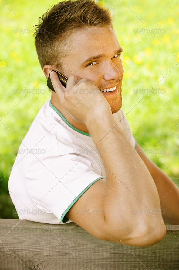 young man talk on mobile phone - Stock Photo - Images