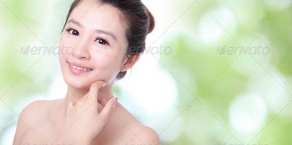 Young woman smile and hand touch face - Stock Photo - Images