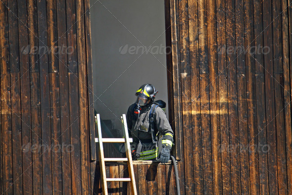 firefighter with mask off a dangerous fire - Stock Photo - Images
