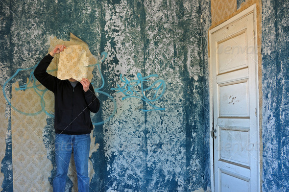 man with torn wallpaper - Stock Photo - Images