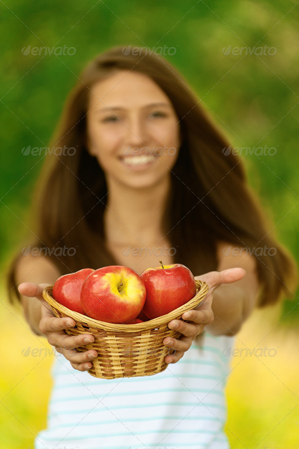 woman holding basket with apples - Stock Photo - Images